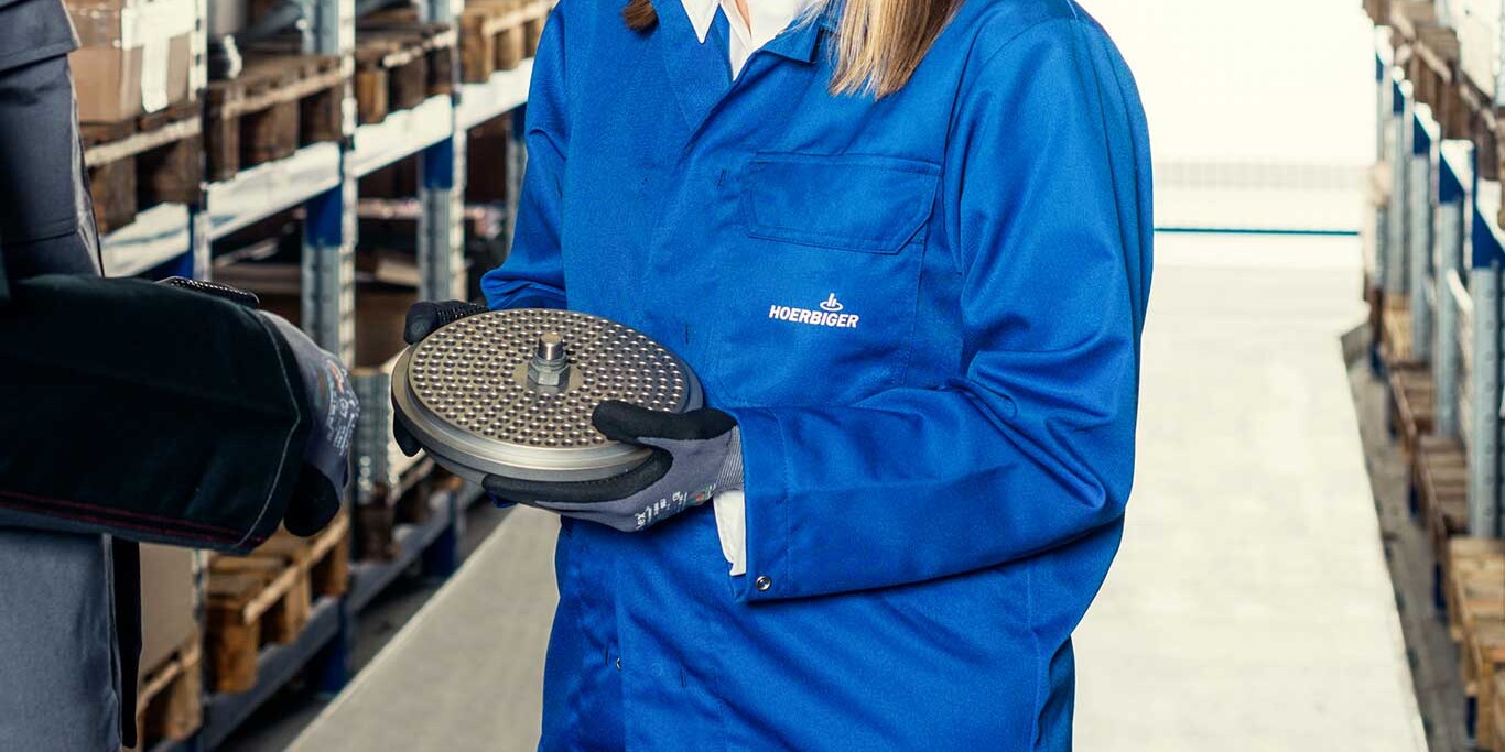 Reliable supply of spare parts A warehouse with spare parts and a valve in focus